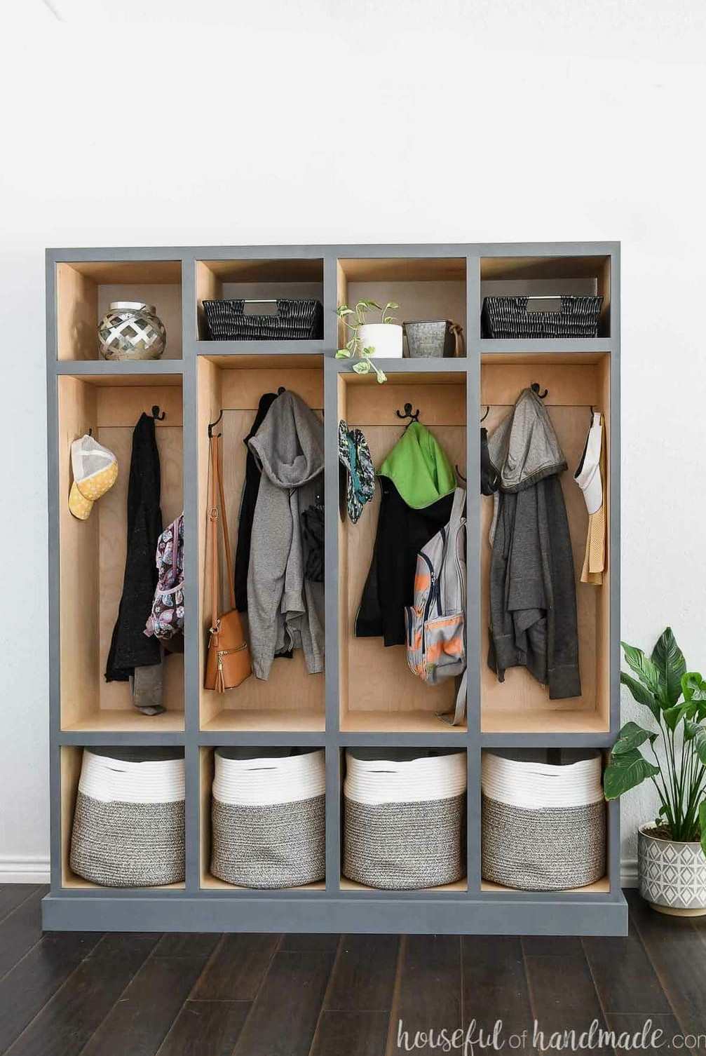 Front view of the mudroom lockers with a plant beside them.