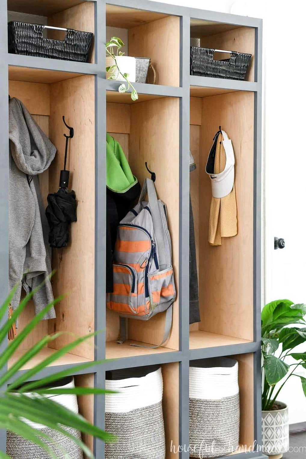 Close up view of the side hooks in the center compartment of the mudroom storage cabinet.