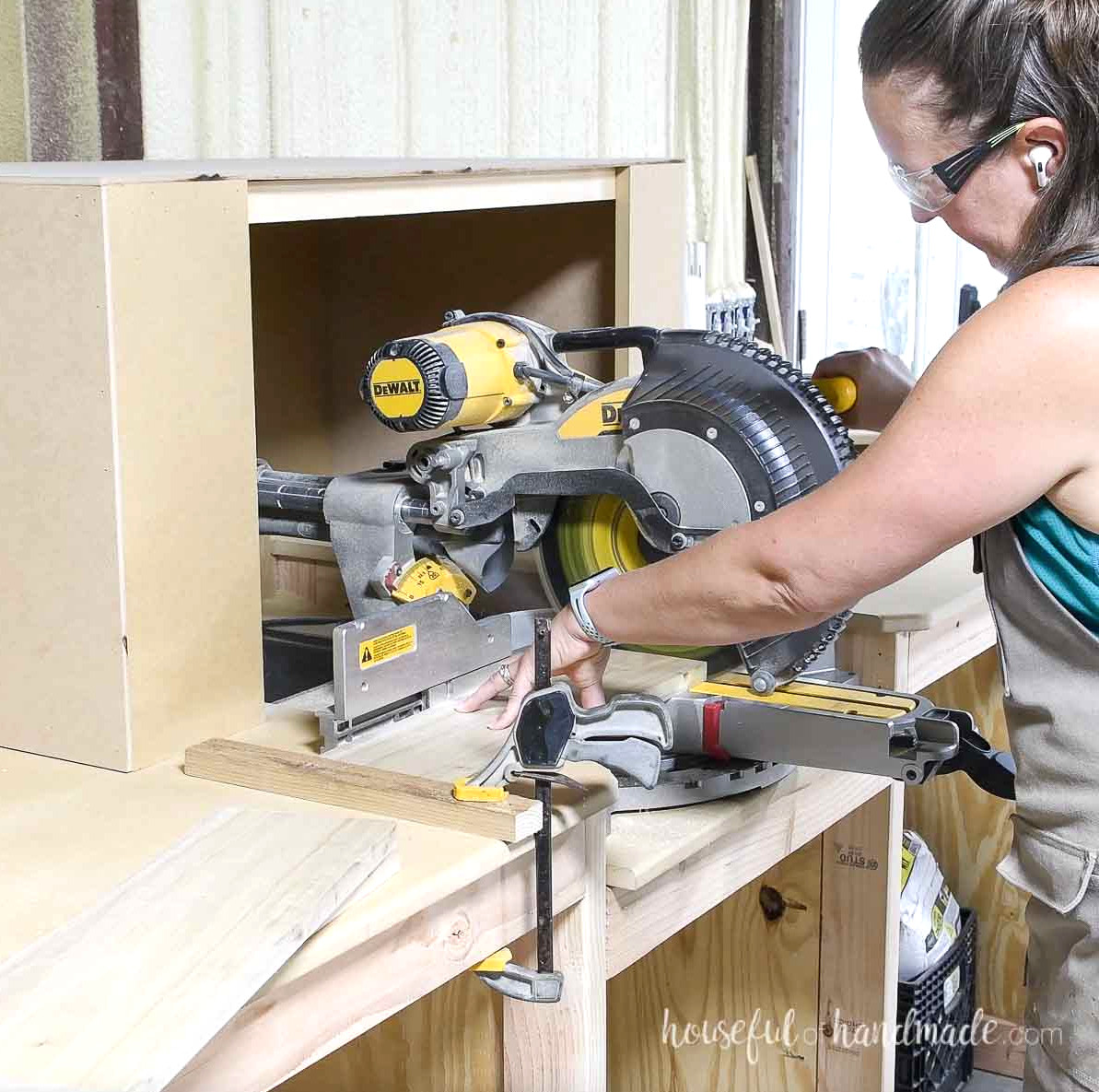 Cutting boards on a miter saw using a scrap wood as a stop.
