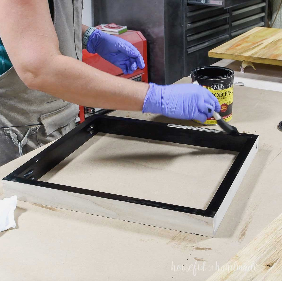 Applying black stain to the table apron. 