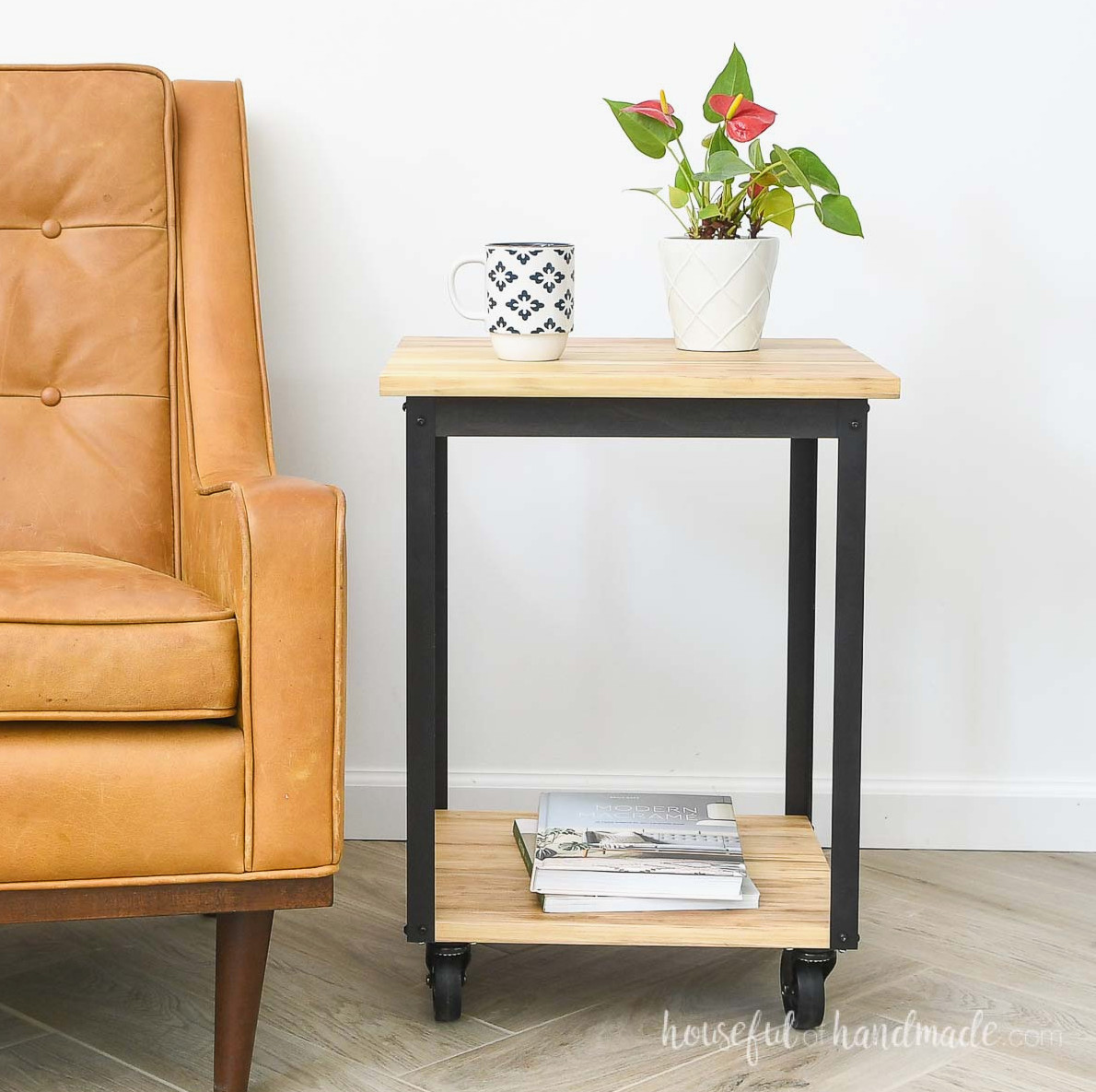 DIY side table with wheels and metal frame next to a chair.