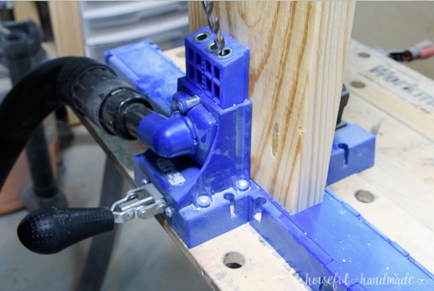 A close view of pocket holes being drilled into the 2x8 boards with the Kreg K5 pocket hole system.