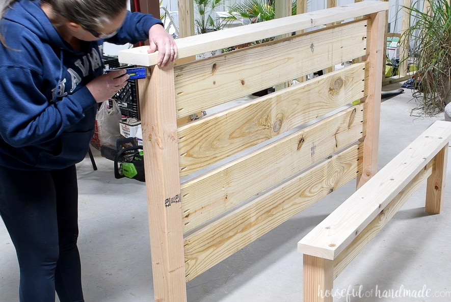 Aligning the headboard top before securing it.
