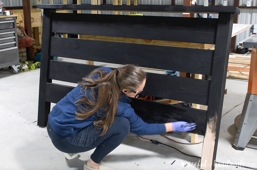 Applying True Black wood stain to the headboard.