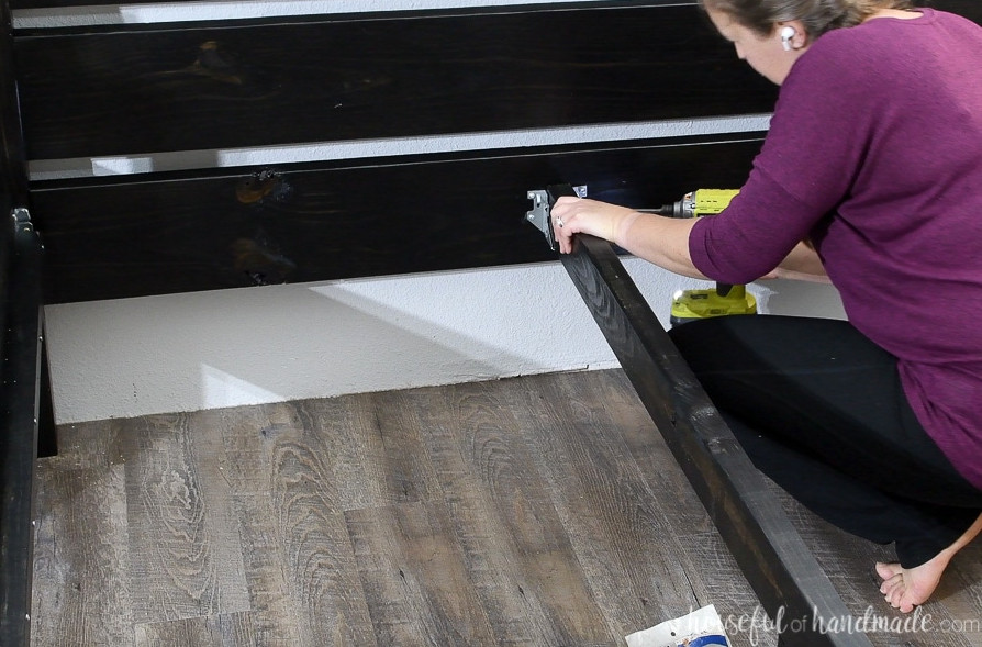 Adding the center support to the headboard with a joist hanger.