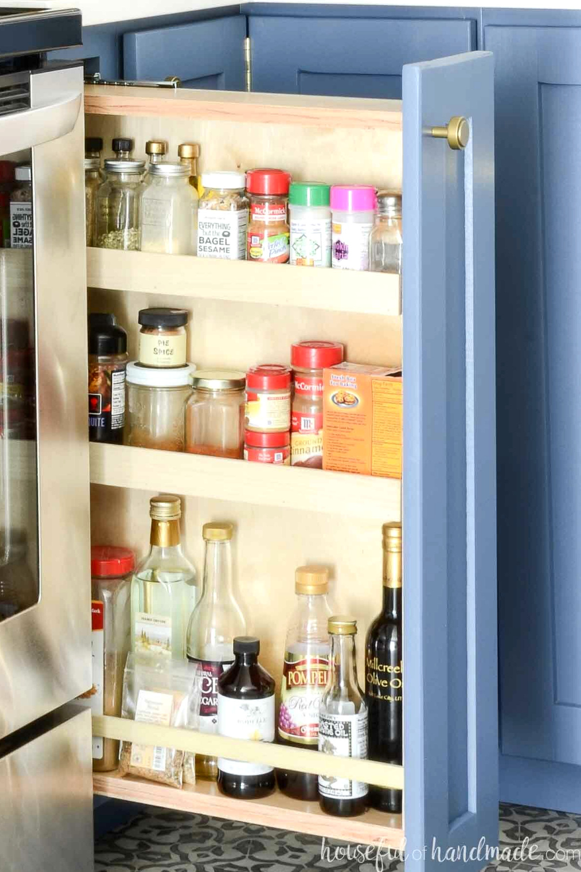 DIY pull-out spice cabinet constructed from plywood. 