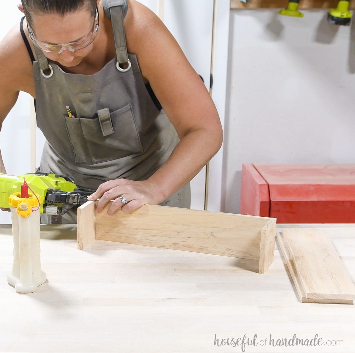Attaching the sides of the bin to the bottom with brad nails.