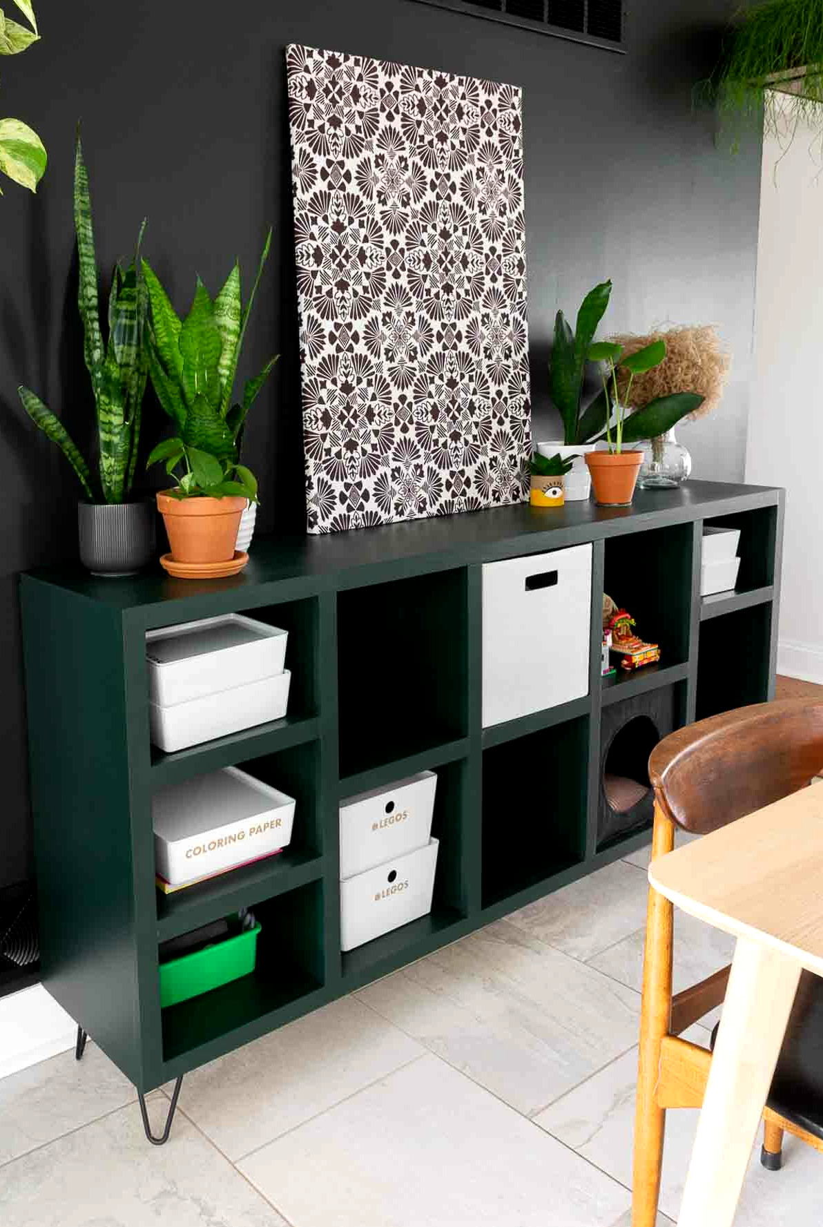 Cube storage bins inside a DIY console table finished with contemporary moody paint.