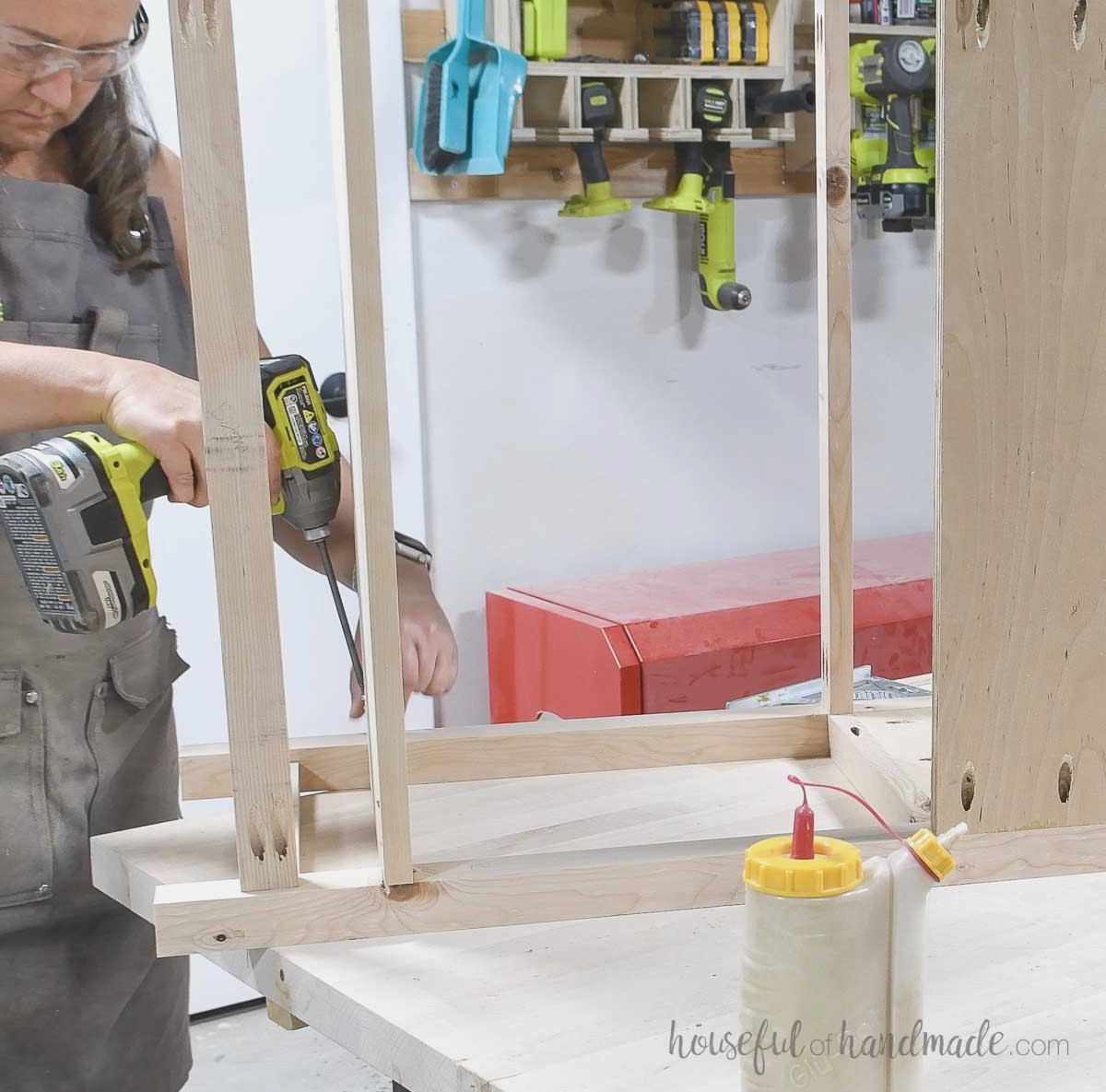 Fastening the bottom shelf to one side piece. 