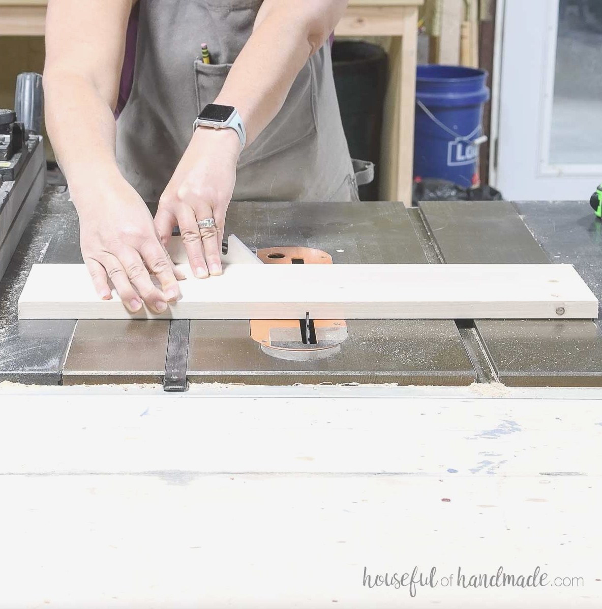 Cutting a groove in the center of the drawer front piece with a table saw. 