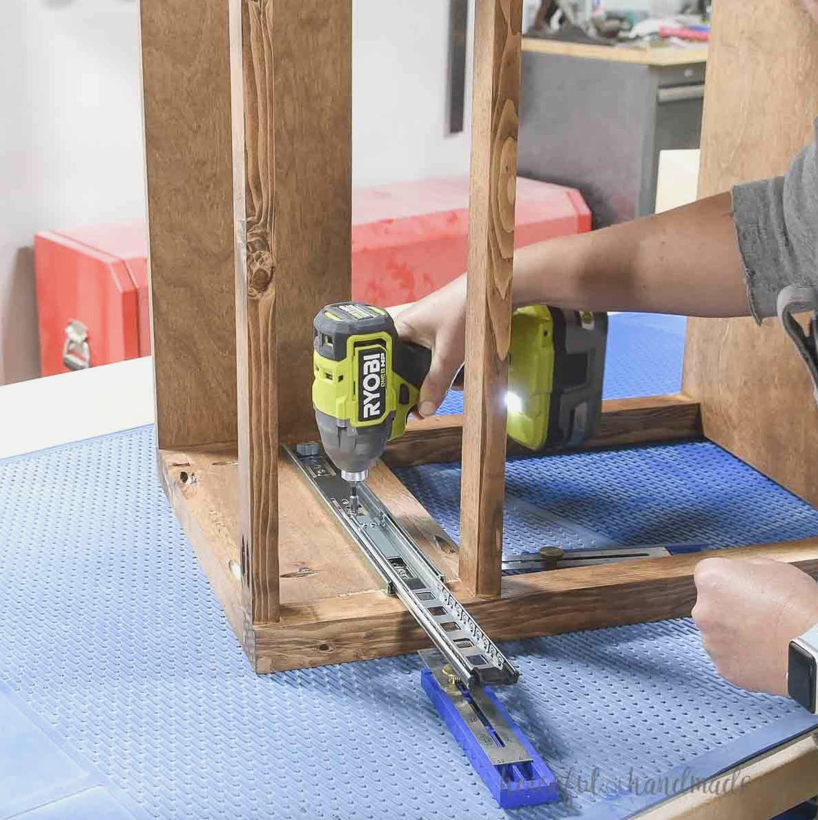Mounting drawer slides on the side of the nightstand.