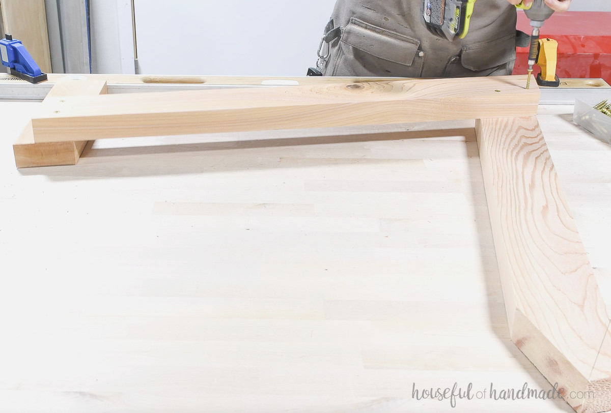 Joining the front and back legs with the under-seat board.