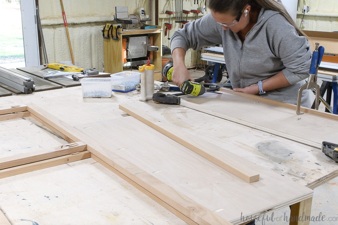 Attaching the 1x2 board to the front of the shelf boards.