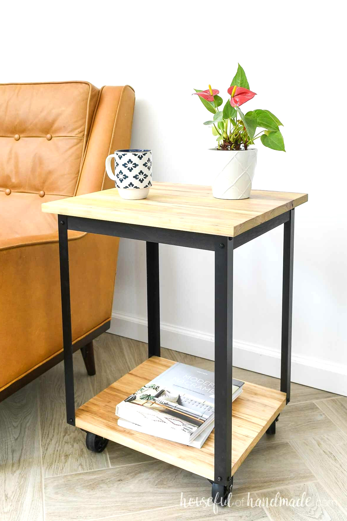 DIY end table on wheels next to a brown leather chair. 