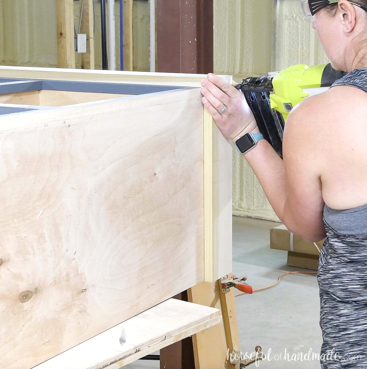 Fastening the 1x4 base to the mudroom cabinet.