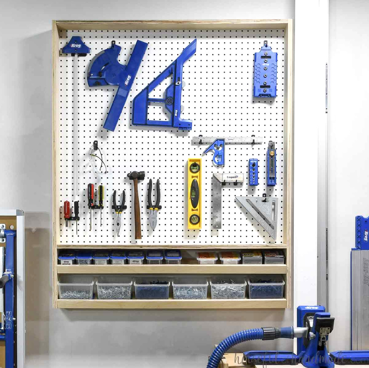 Pegboard storage organizer for tools and screws hanging on a wall. 