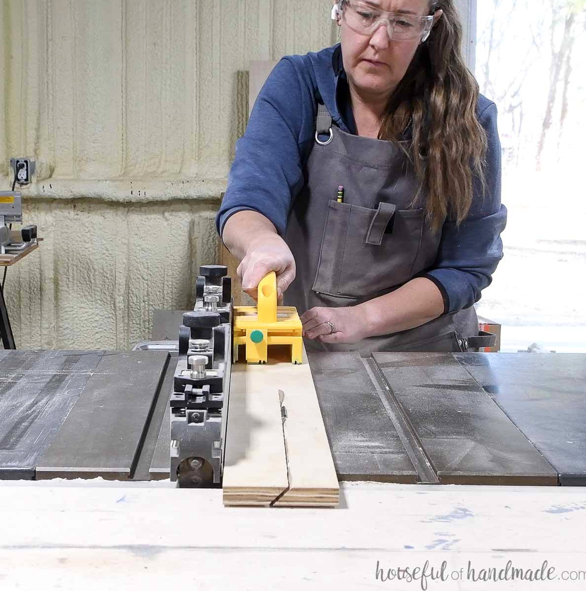 Ripping a piece of plywood in half at an angle to create a french cleat. 