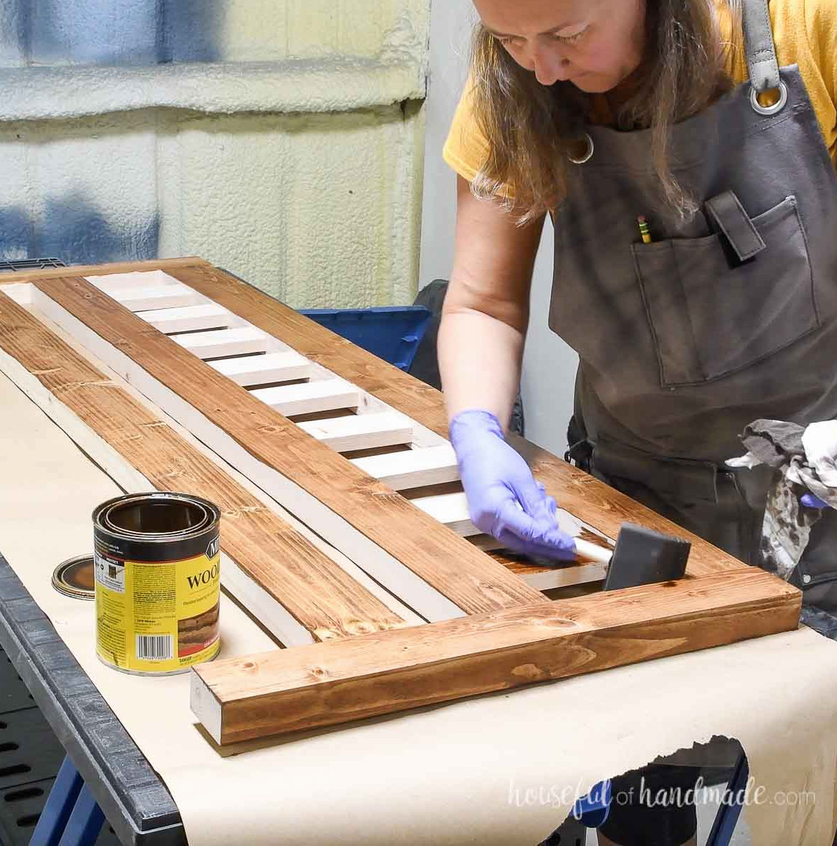 Staining the 2x4 DIY bed with Early American stain by Minwax. 