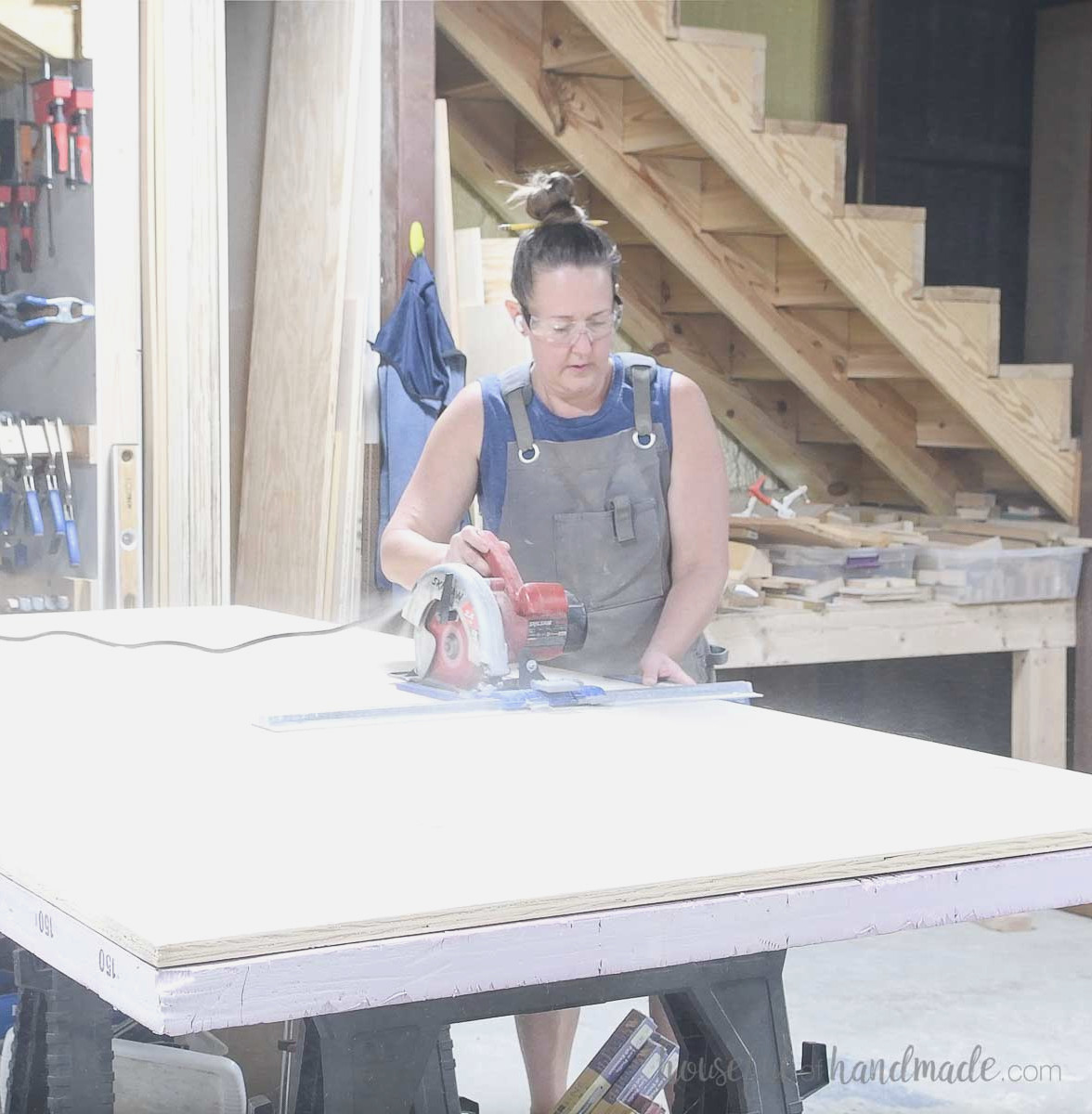 Cutting plywood on a piece of rigid foam with a circular saw and guide.