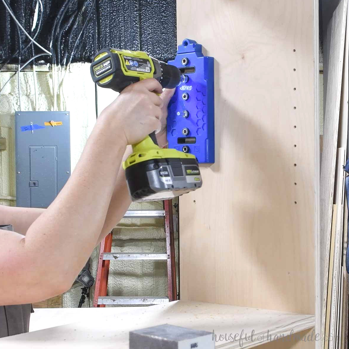 Drilling shelf pin holes using a shelf pin jig.