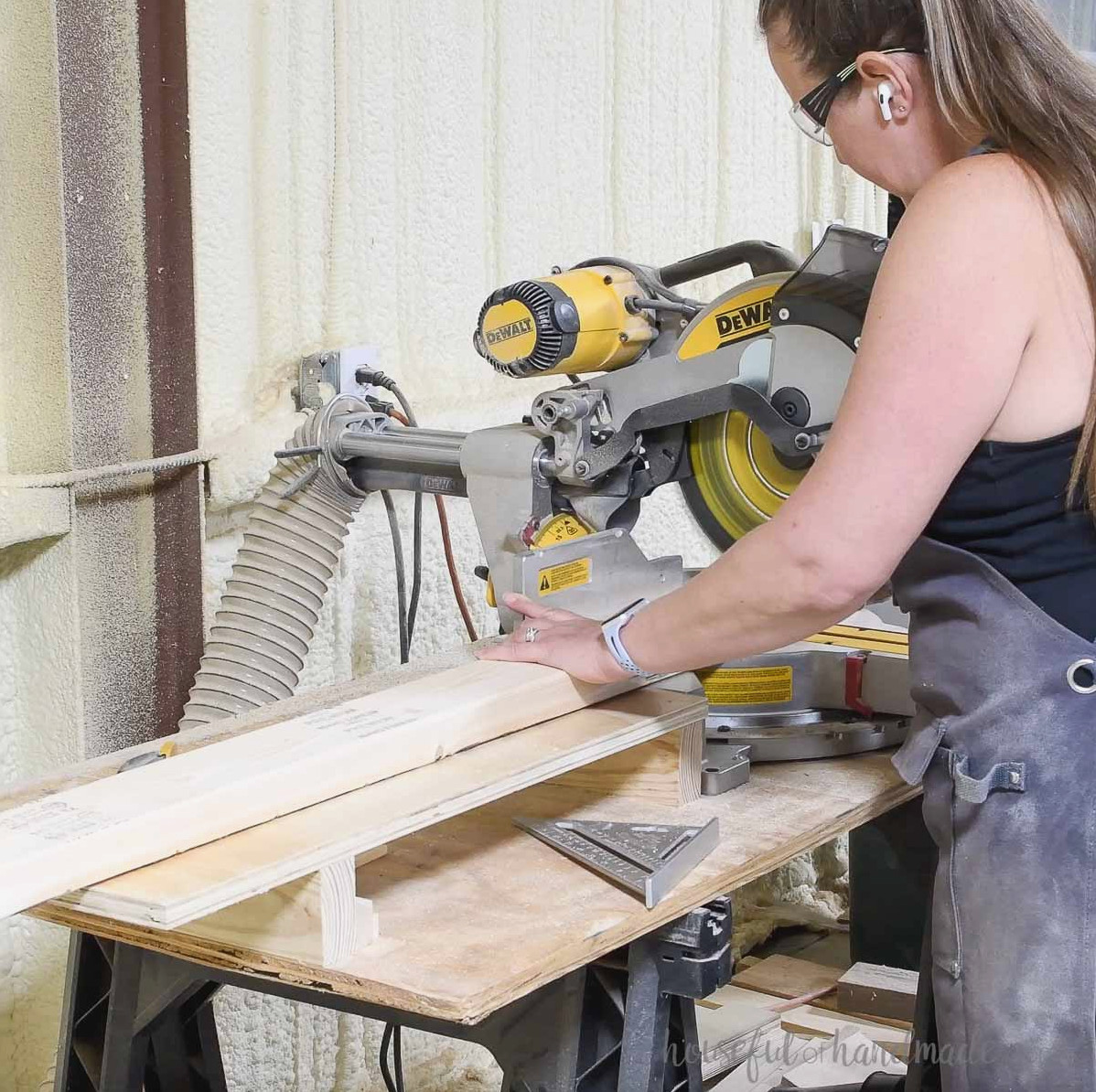 Cutting 2x4 boards on a miter saw.