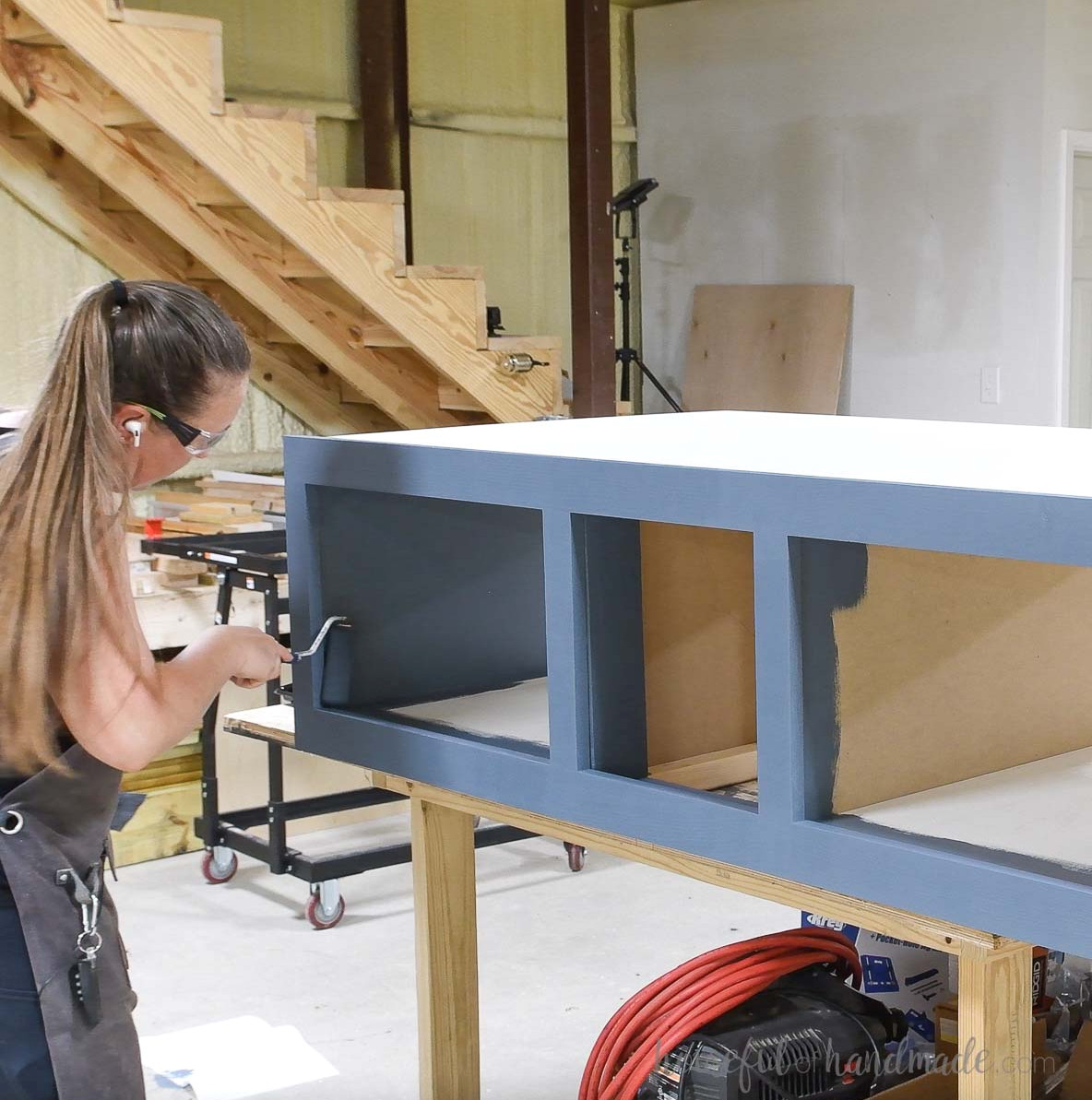 Painting the completed laundry platform blue. 