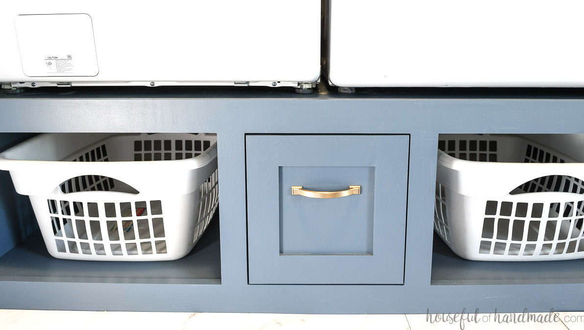 Two laundry baskets and a drawer in the washing machine pedestal. 