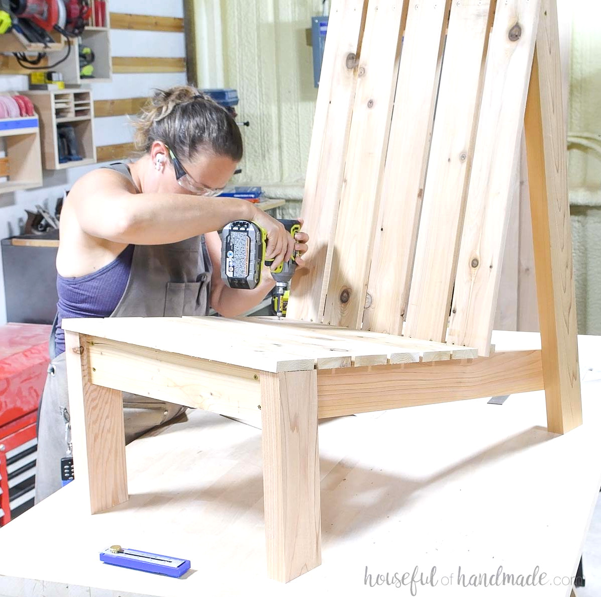 Fastening the last seat slat with screws.