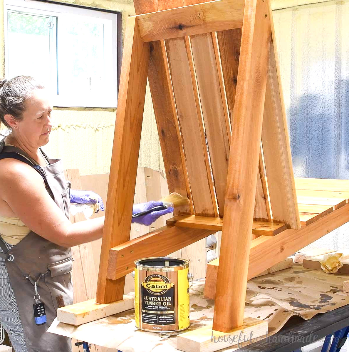 Applying Cabot Australian Timber Oi to seal the cedar Adirondack chair.