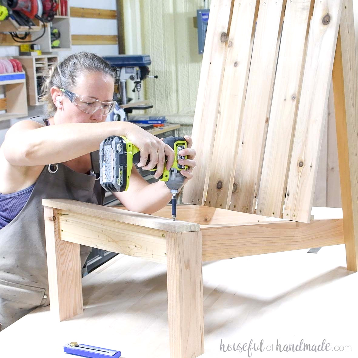 Fastening the front seat slat to the Adirondack chair.