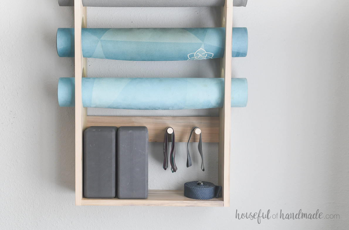 Close up of the yoga block and resistance bands storage area on the mat holder. 