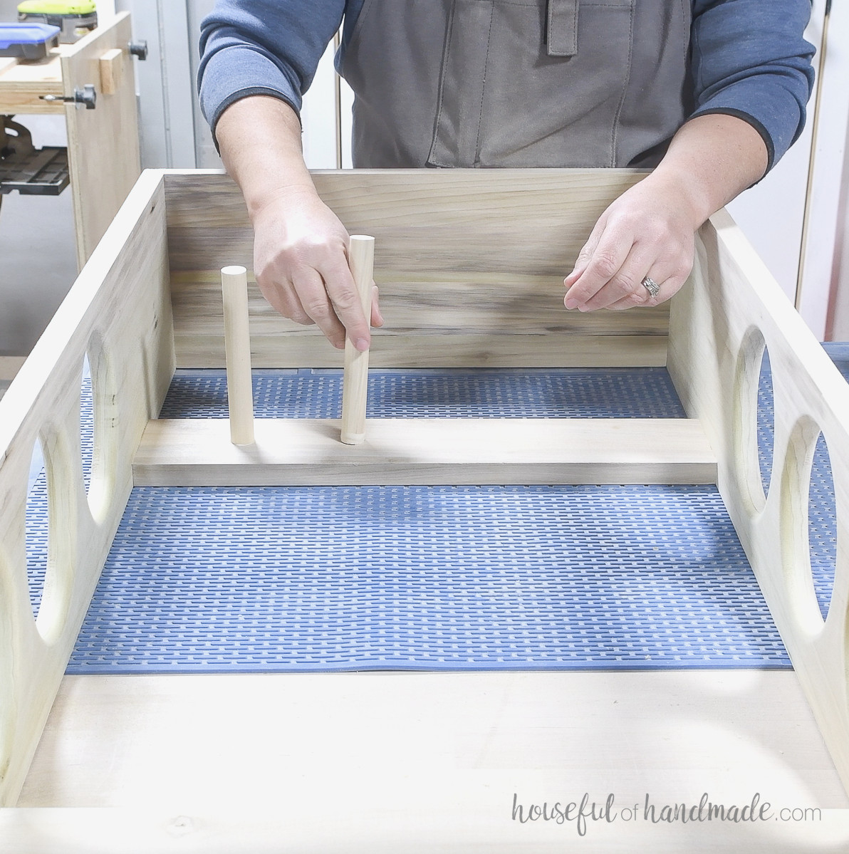 Gluing dowels into the openings of the back board. 
