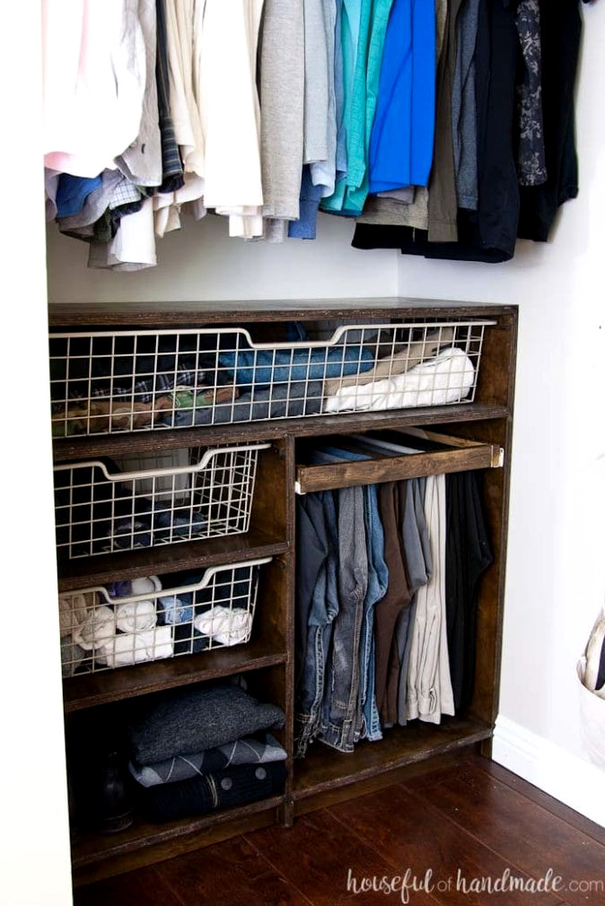 DIY closet storage system featuring plywood baskets and shelves.