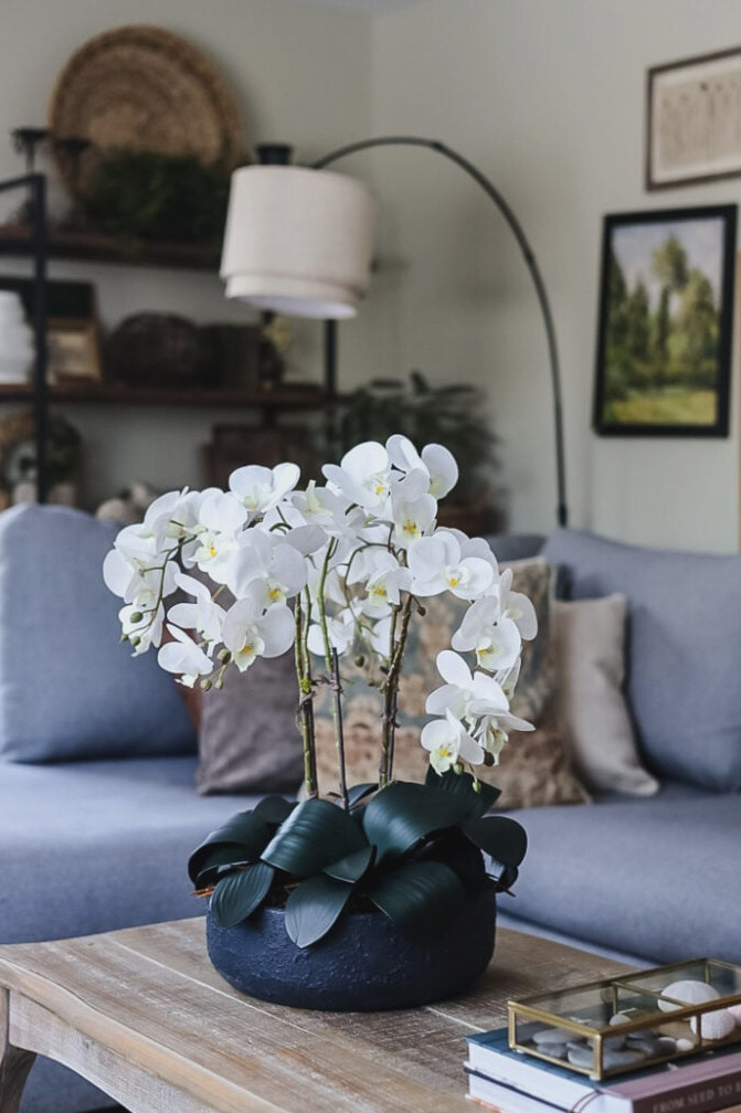faux orchid arrangement on a coffee table