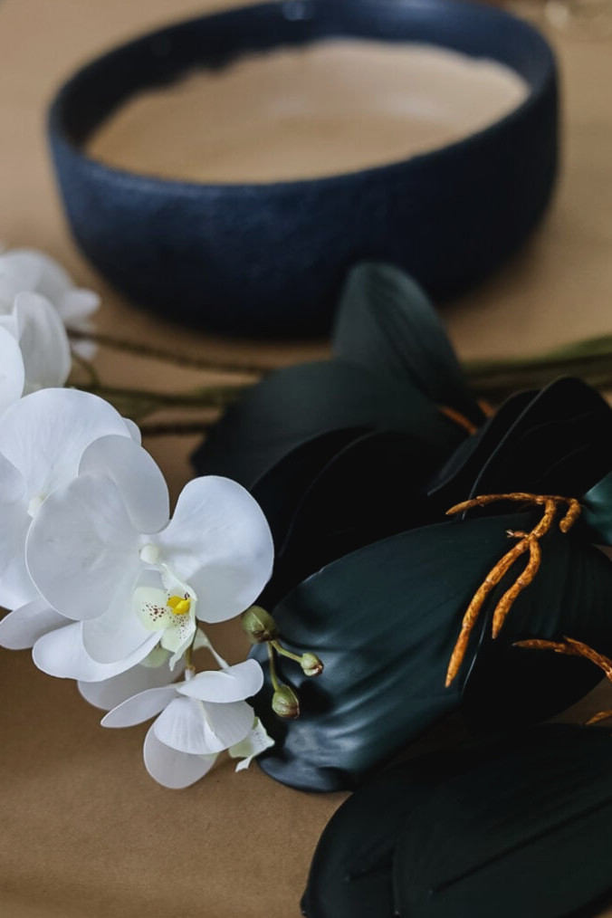 artificial orchid stems and a planter