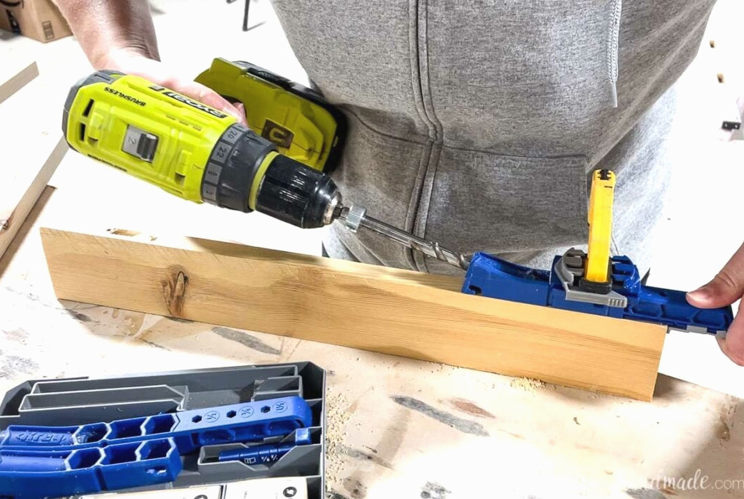 Making a pocket hole along the edge of the 1x3 board with the Kreg jig 320.