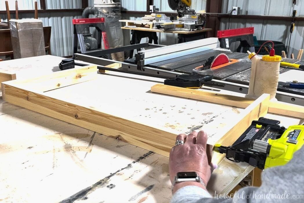 Assembling the shelf box from 1x3 boards with a nail gun. 