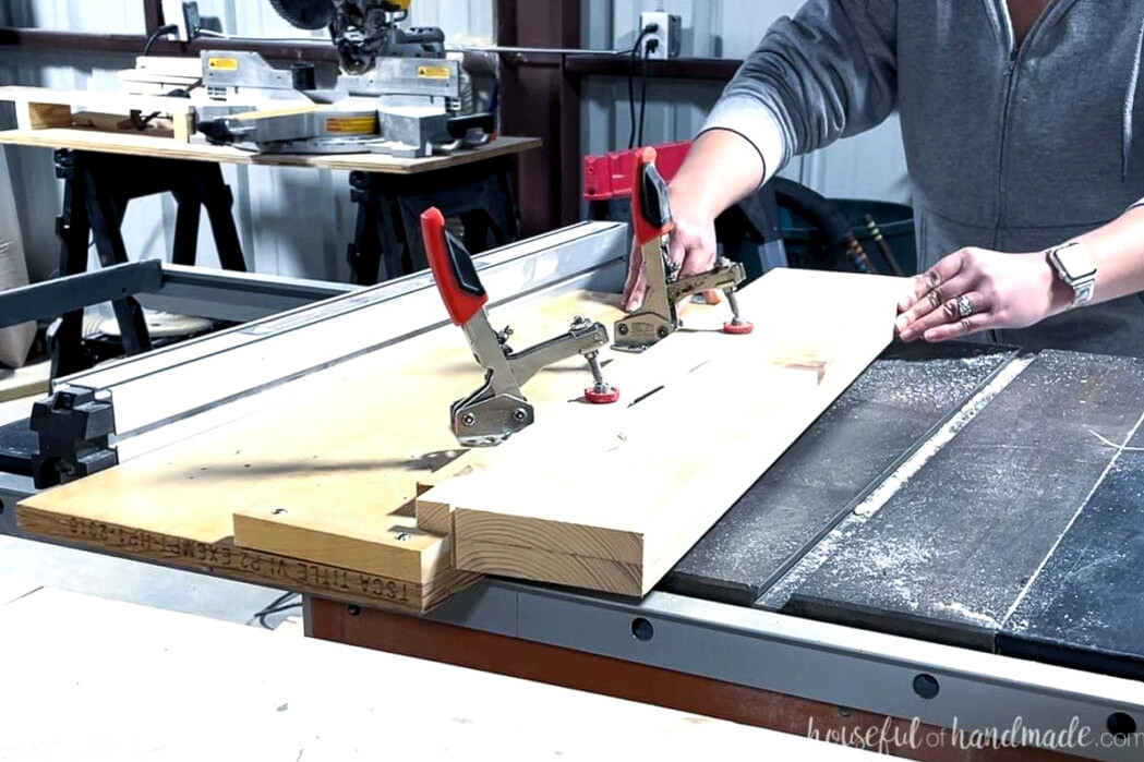 A bathroom vanity leg being tapered on a table saw using a homemade tapered-leg jig.