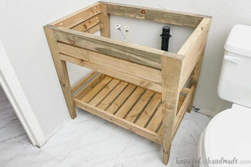 Image of the completed DIY bathroom vanity featuring an open shelf and angled legs. 