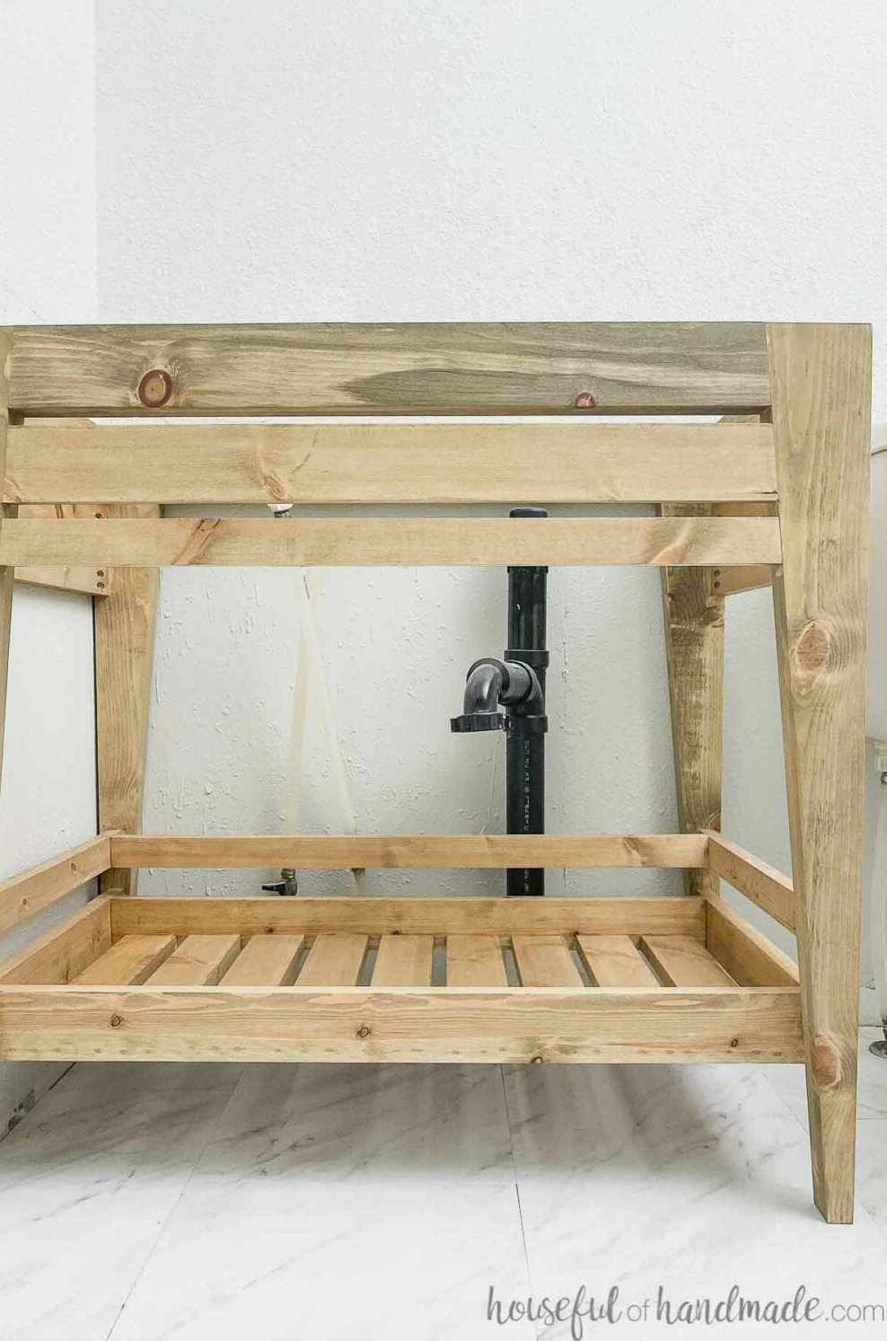 Close-up view of the bathroom vanity constructed from affordable lumber for the budget-friendly bathroom renovation. 