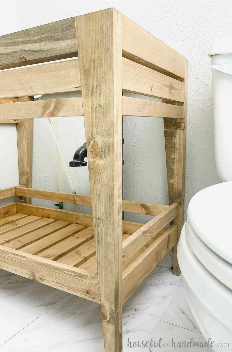 Side perspective of the tapered legs and ornamental skirt on the DIY bathroom vanity. 