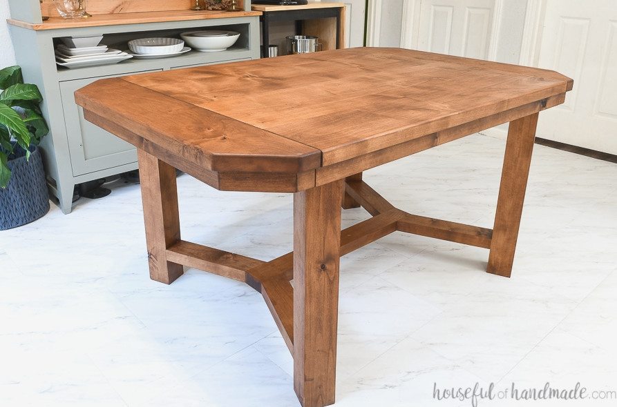 Dining table featuring breadboard ends that open to hold leaves, finished with a matte, unfinished-style sealer. 
