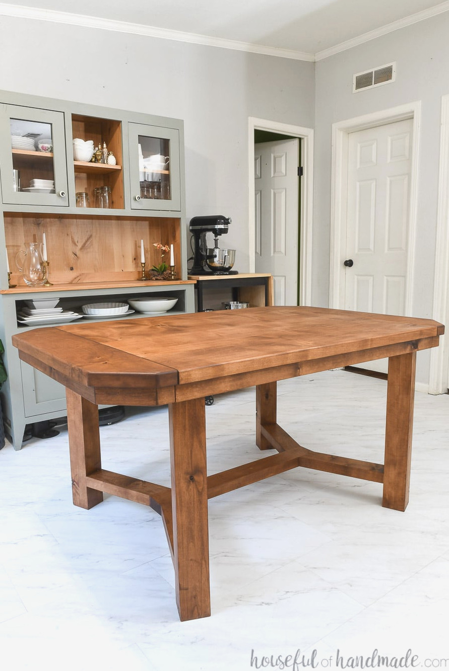 Dining area featuring a DIY dining table in front and a hutch behind it, both crafted from alder wood. 