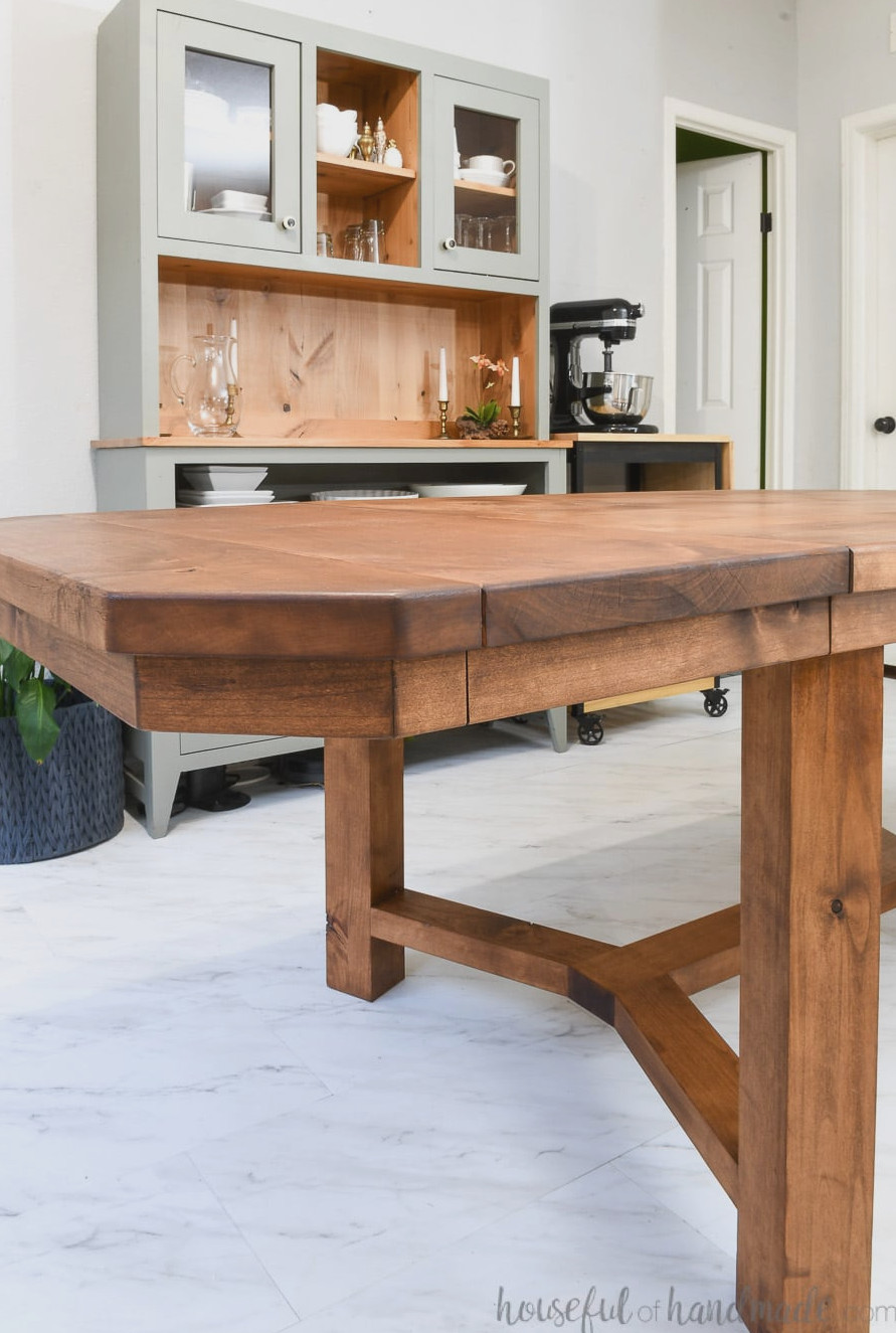 Close-up view of the end of the DIY dining table with leaves in the dining room, without any chairs surrounding it. 