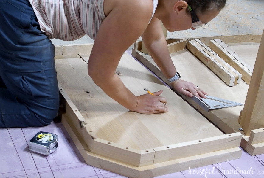 Measuring the location of the table extension slides on the underside of the table. 