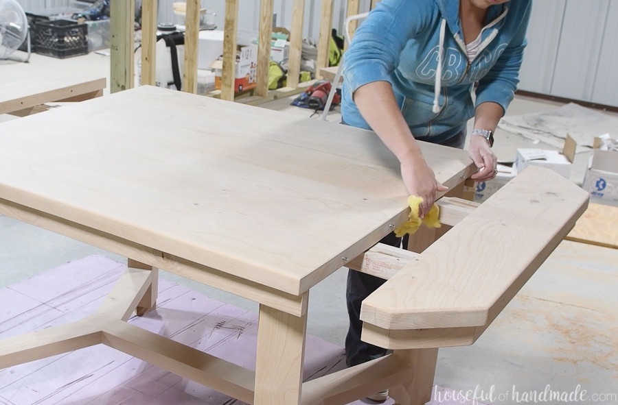 Dusting the table top off with a tack cloth.
