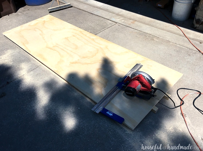 Plywood being cut into 15" wide strips with a circular saw and guide. 