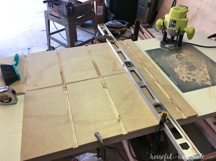 Cabinet sides with all shelf grooves routed using a level clamped to the boards as a guide. 