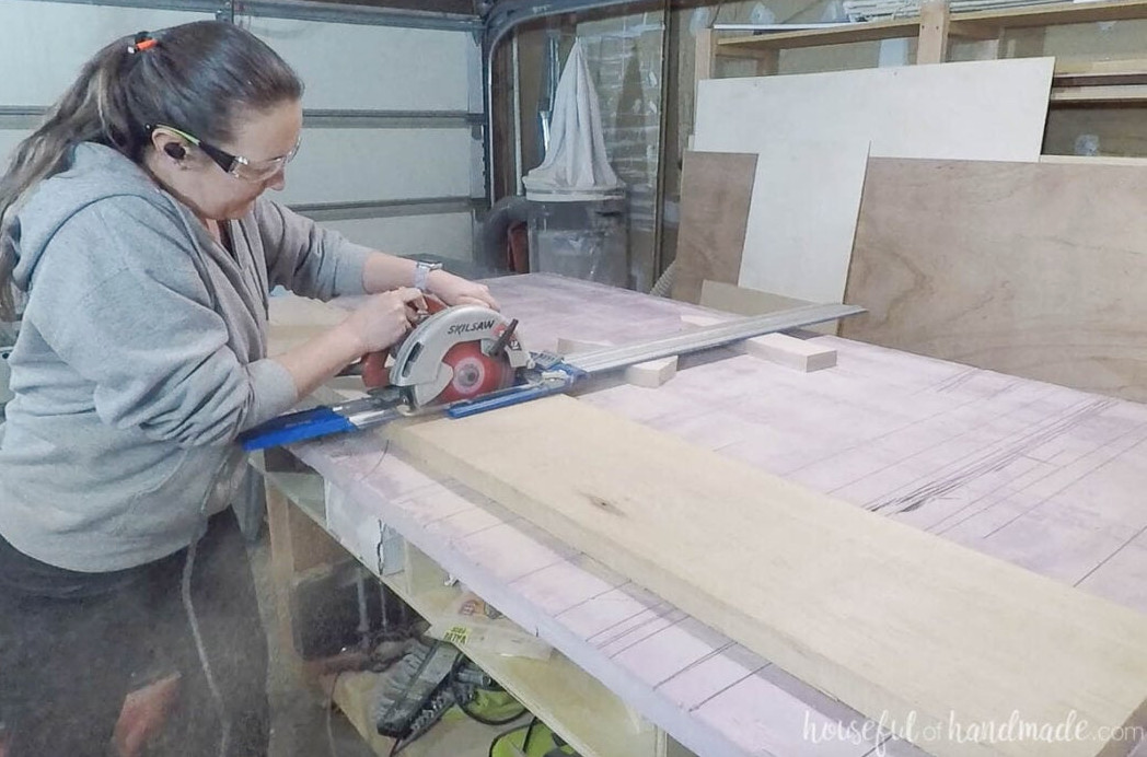 Using a circular saw and guide track to cut the bench seat.