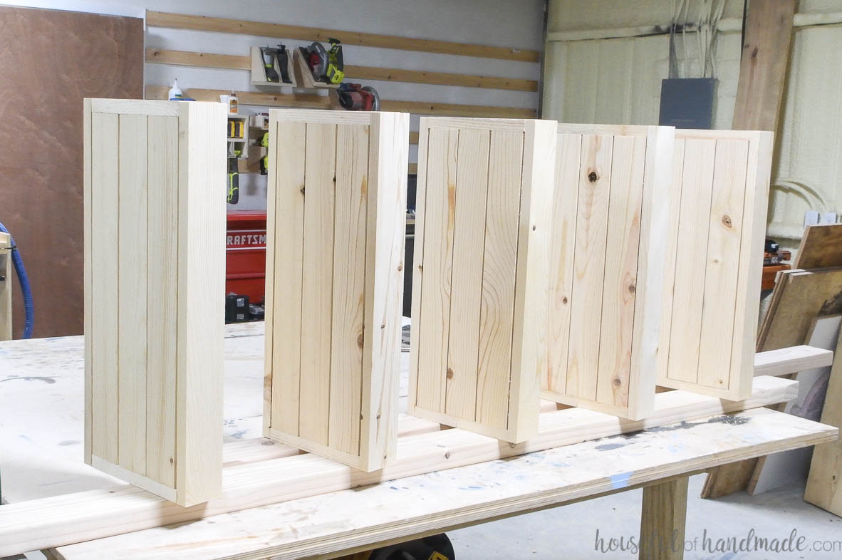 All planter boxes secured to a single side piece.